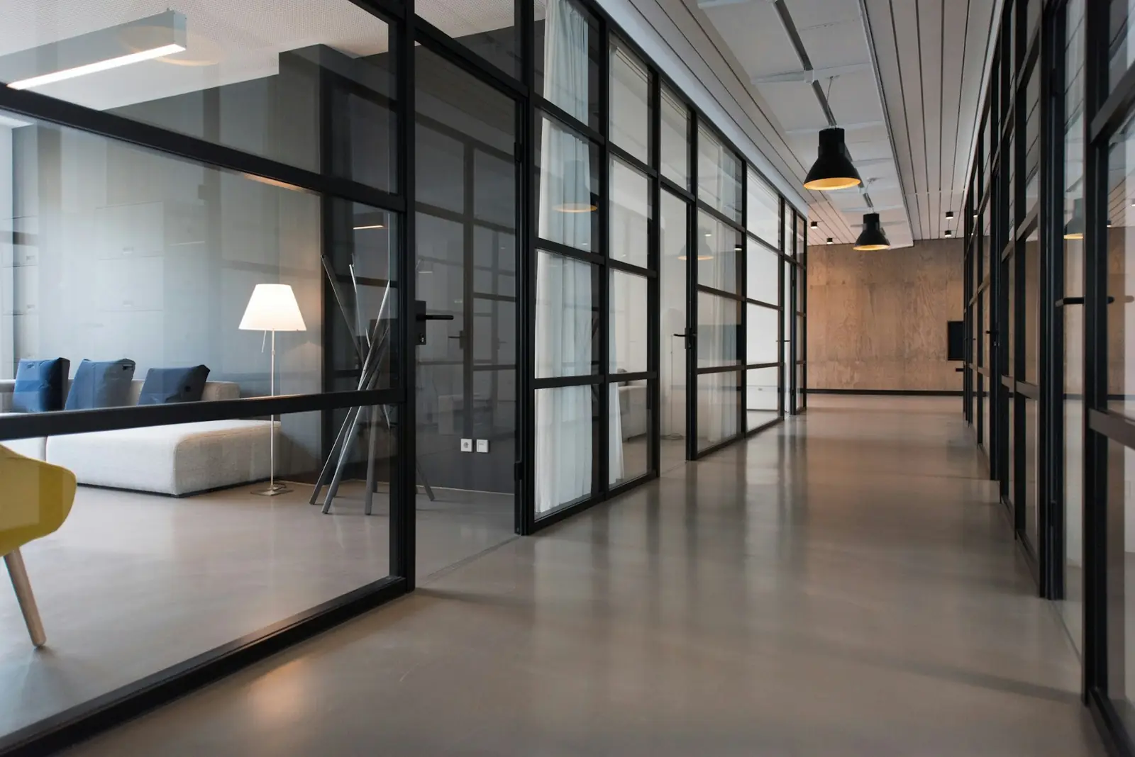 Modern office corridor with glass partitions