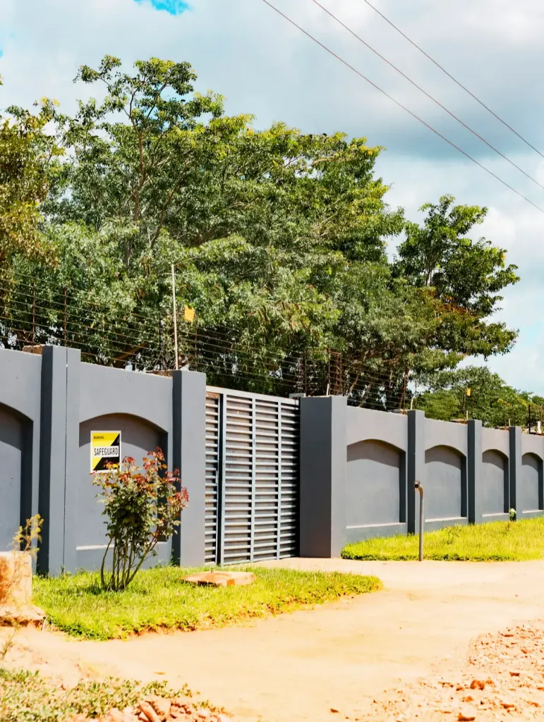 Perimeter wall with security gate and electric fence around a property