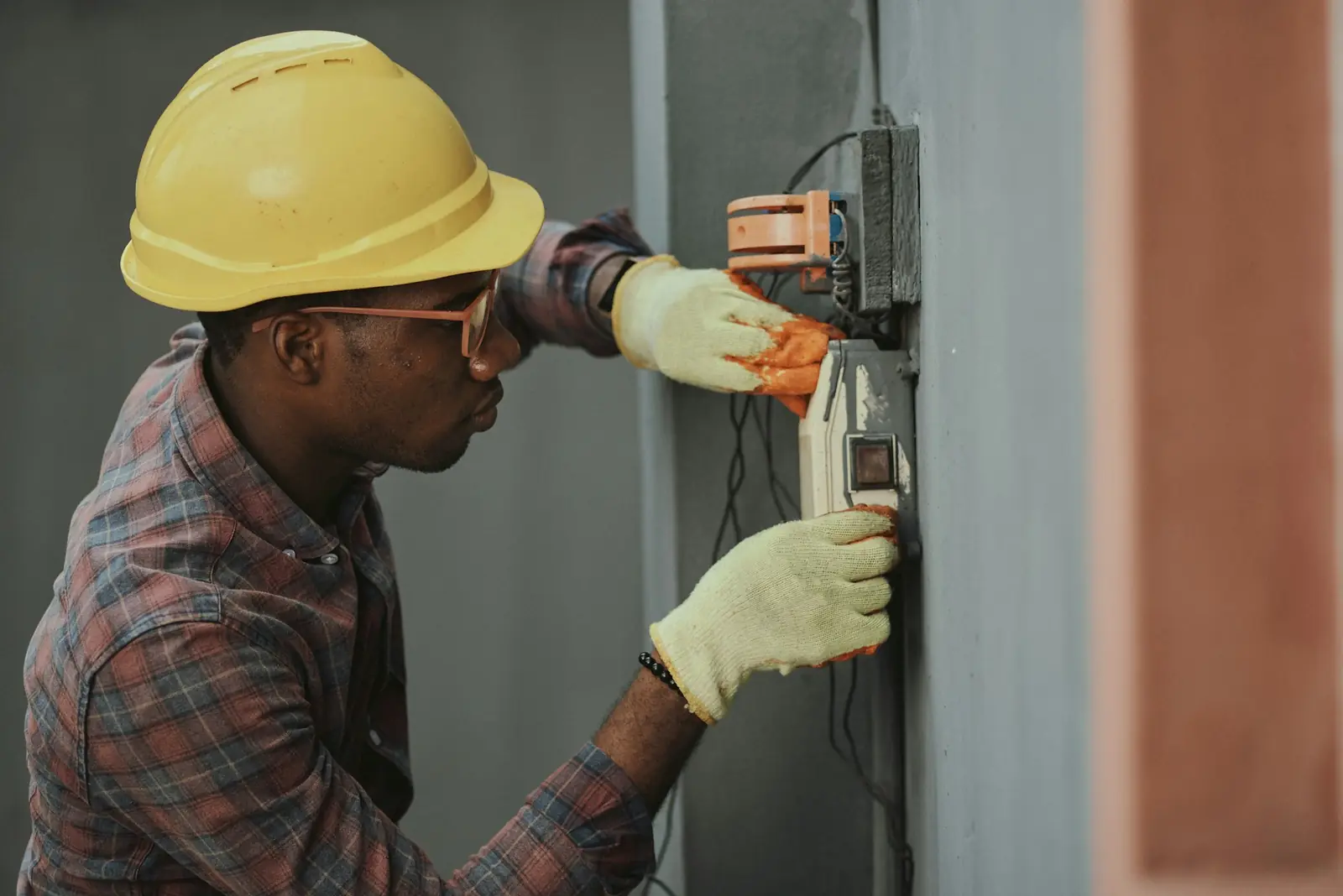 Technician installing security equipment on a wall