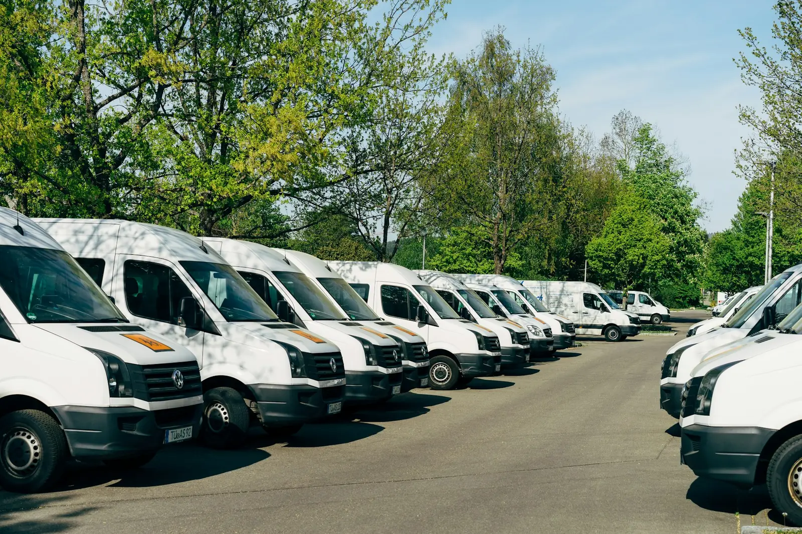 Fleet of white vans parked at a depot