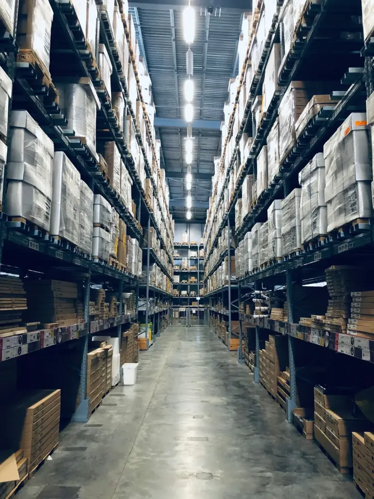 Warehouse aisle with high racking and stock